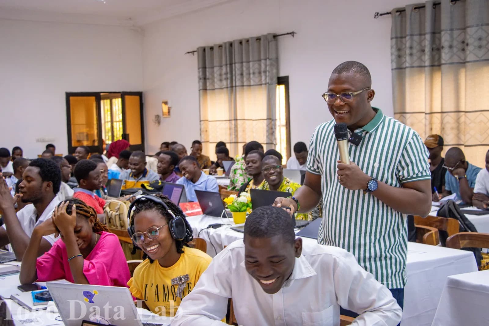 Intervenant au micro face à une salle de participants travaillant sur leurs ordinateurs, lors de la masterclass Togo Data Lab